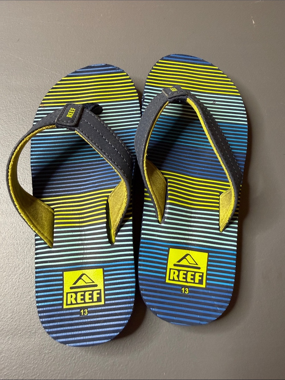 Kid’s Reef Blue & Yellow Striped Flip Flops. Size: 13